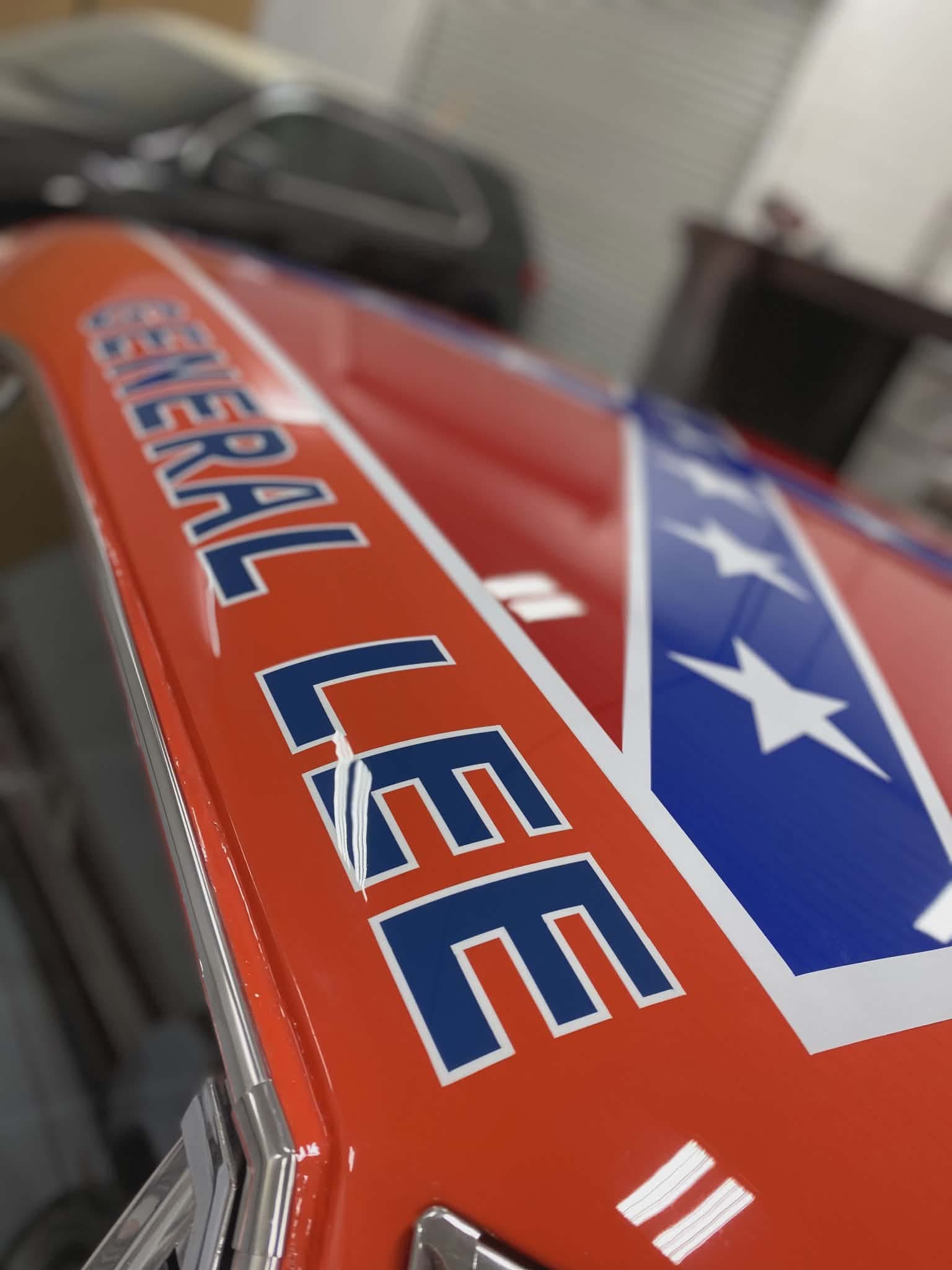 Show-quality orange muscle car finished after bodywork and paint