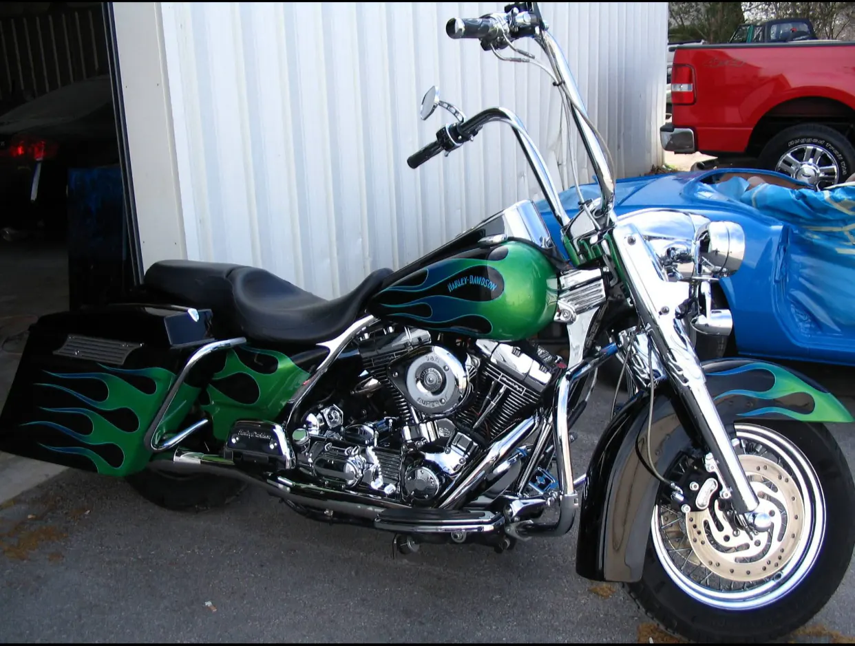 Green and black Harley-Davidson motorcycle with custom flames