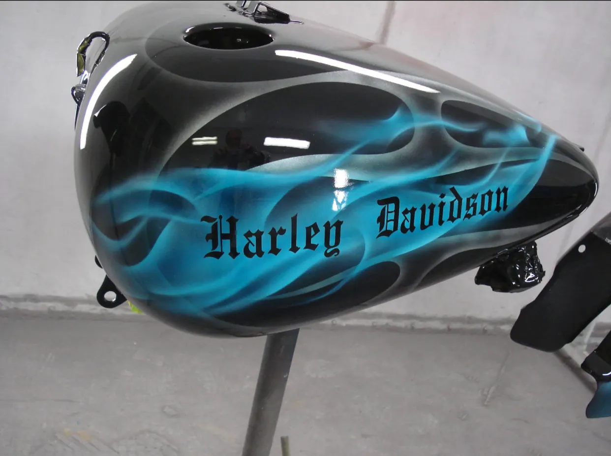 Harley-Davidson fuel tank with blue flame-style custom paint