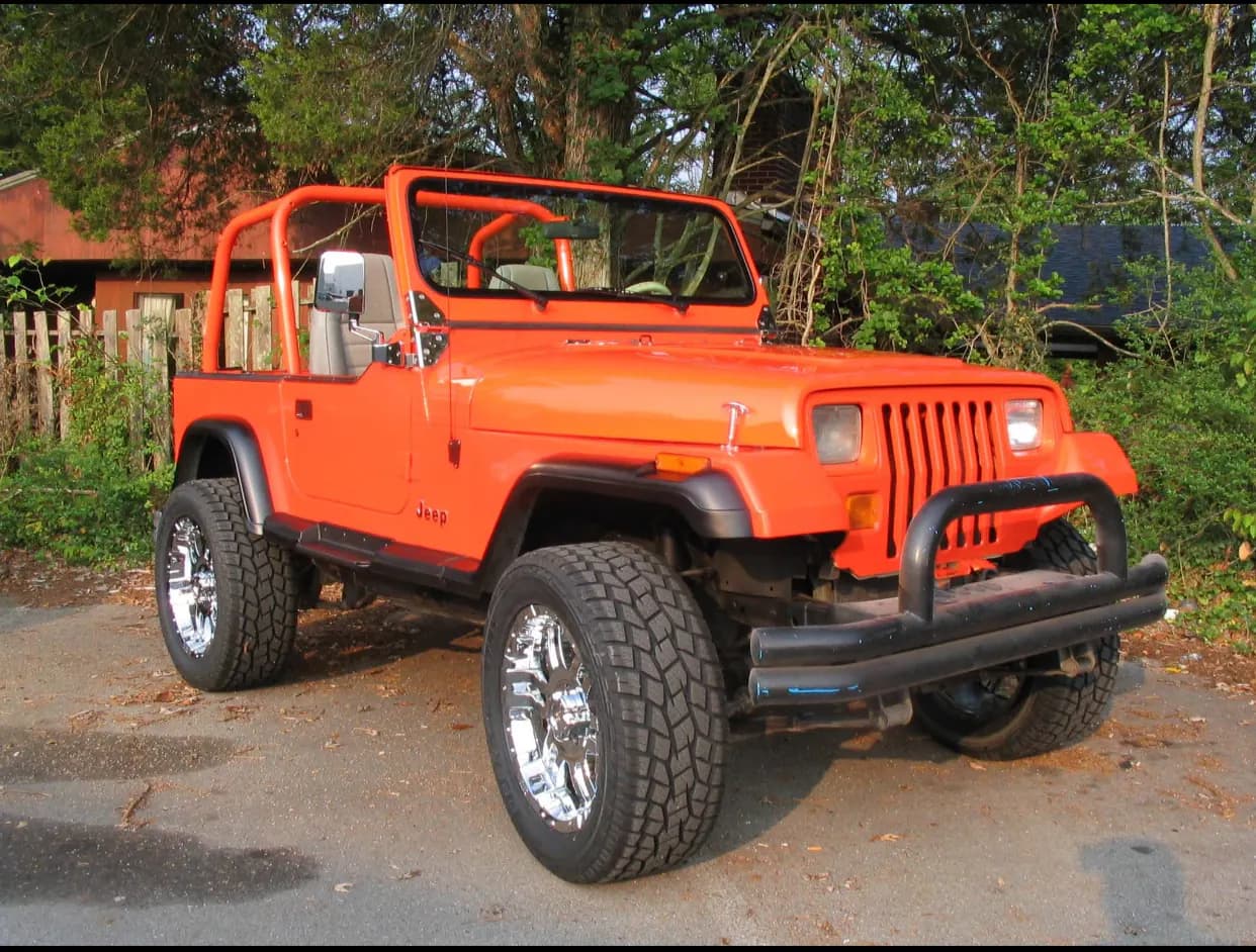 Orange custom Jeep Wrangler parked outdoors